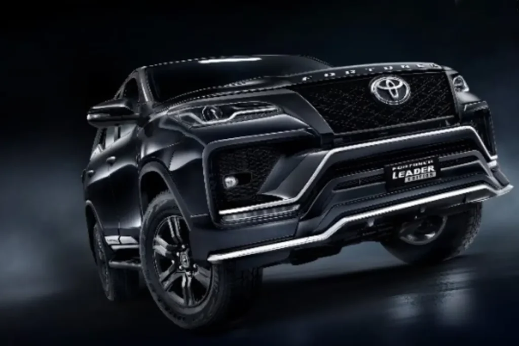 2025 Toyota Fortuner SUV showcasing new exterior design, LED headlights, and bold stance parked on an open highway during sunset.