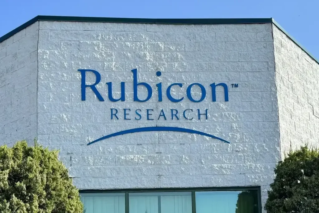 Upward green arrow with DNA helix and capsules symbolizing Rubicon Research IPO growth and positive market trend.