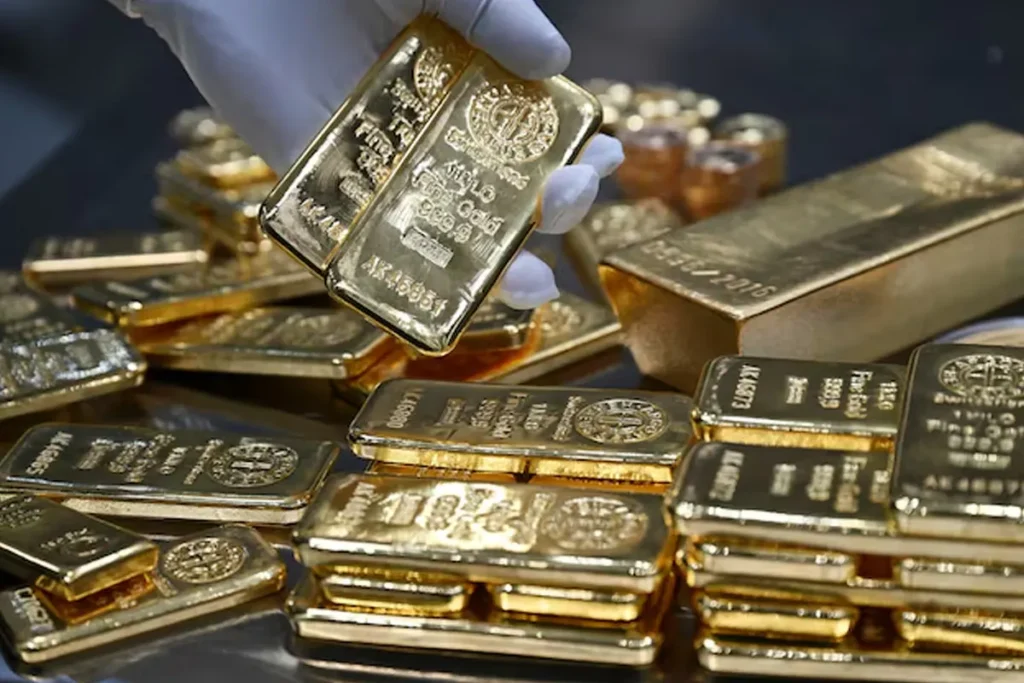 Shining gold bars and coins representing the record-breaking gold price trend in 2025 India market.