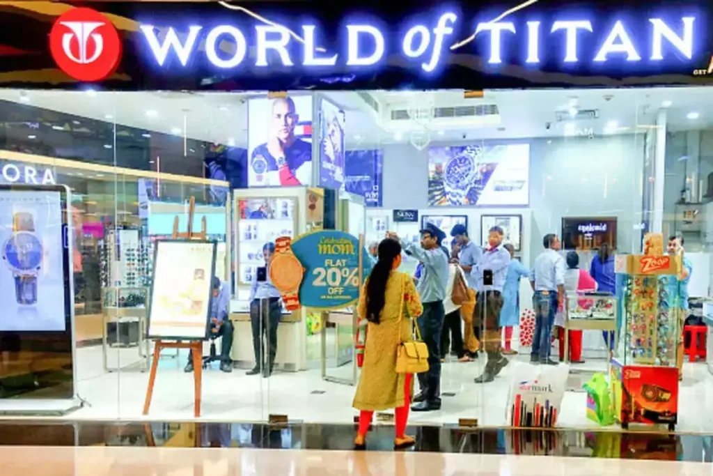 Titan Stock price soars with upward green arrow inside a Titan jewellery showroom, reflecting strong Q2 growth and market optimism.