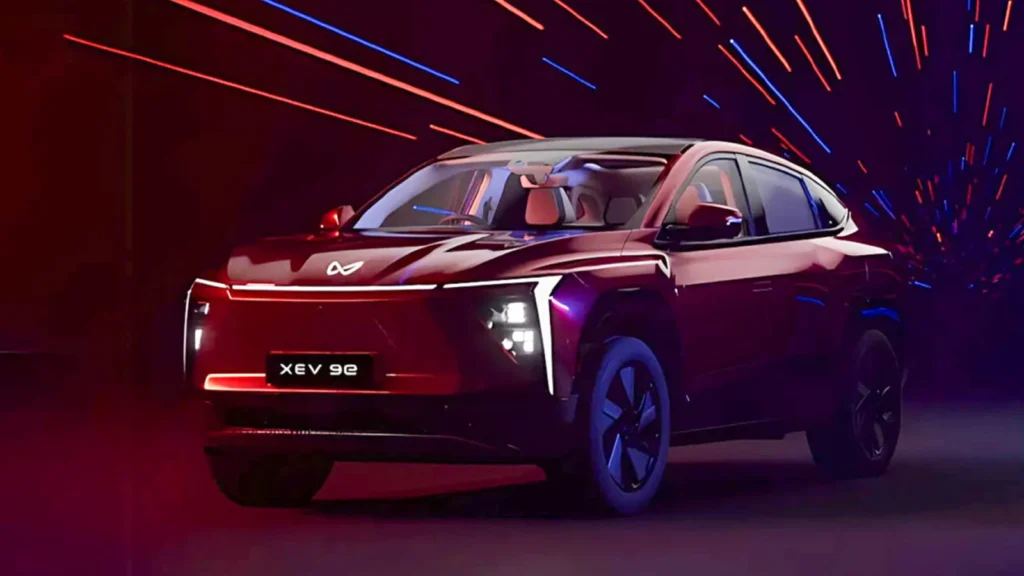 Mahindra XEV 9e 2025 electric SUV seen with sleek coupe profile, bold LED lighting, and modern EV styling.