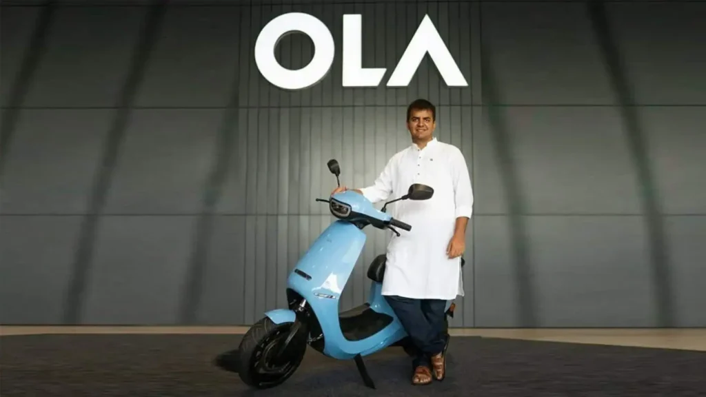 Ola Electric FY26 outlook visual showing an electric scooter with upward trend arrow representing growth and profitability goals.