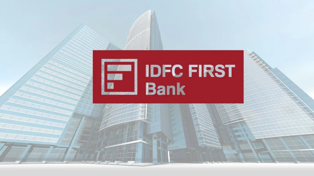 IDFC First Bank building with digital financial graphs and upward-trending stock indicators representing IDFC First Bank’s market performance.